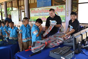 Ben van den Hende, Corporate Vice-President, Supply Chain, Beauty Care, Henkel Asia-Pacific, presenting the computer sets to the children